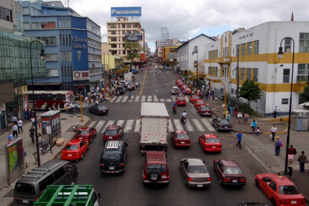 Busy street with cars and people in downtown San José Costa Rica