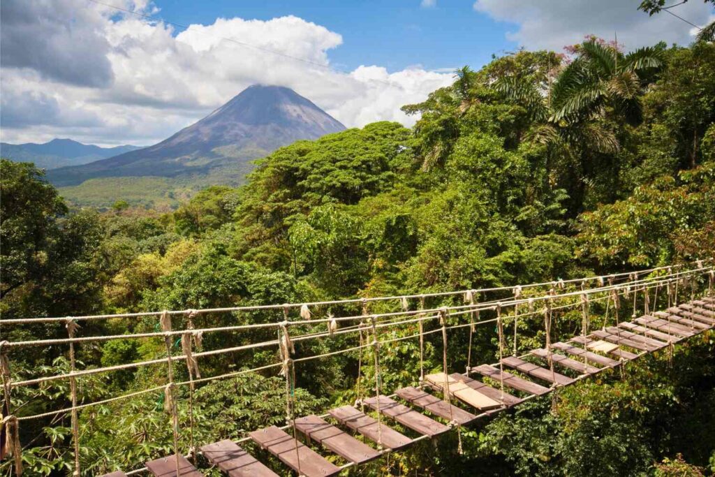Hanging bridge with Arenal Volcano in the background.
