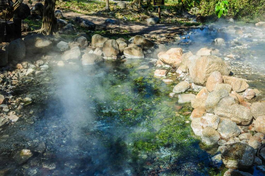 Natural hot spring with steam rising in Costa Rica.