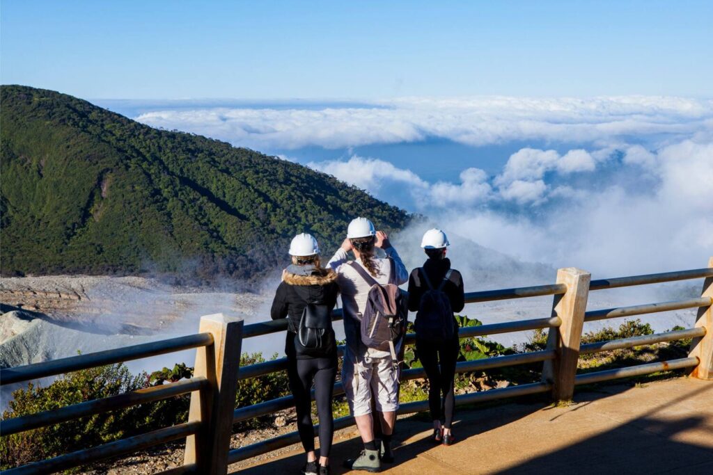 People observing Poás Volcano above the clouds