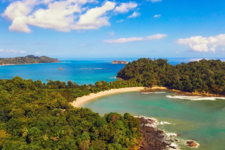 Tropical bay at Manuel Antonio National Park with clear water and forested hills